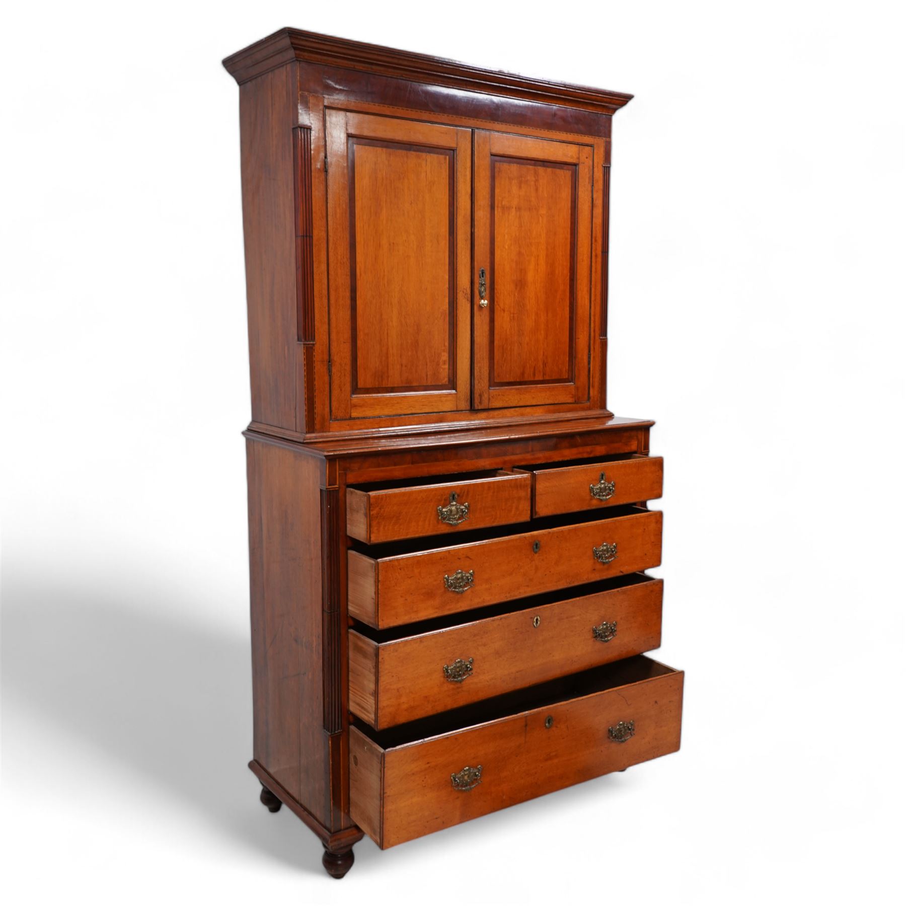 George III oak and mahogany banded house keeper's press cupboard, projecting cornice over figured mahogany frieze with Tunbridge ware pattern bands, two panelled doors enclosing shelves, fitted with two short over three long drawers, flanked by reeded columns throughout, on turned feet