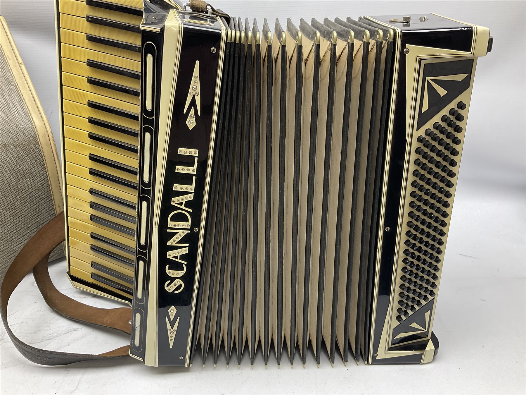 Scandalli Vibrante Three piano accordion in Art Deco black and white case with jewelled decoration, twenty-four keys and one-hundred and twenty buttons; inscribed '5700 Camerano Italia'; serial no.3414 L54cm; in carrying case with strap