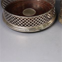 Two silver mounted bottle coasters, the larger example with latticework sides, hallmarked Mappin & Webb Ltd, Birmingham 1993, the smaller example with pierced sides, hallmarked W I Broadway & Co, Birmingham 1998, largest D12cm