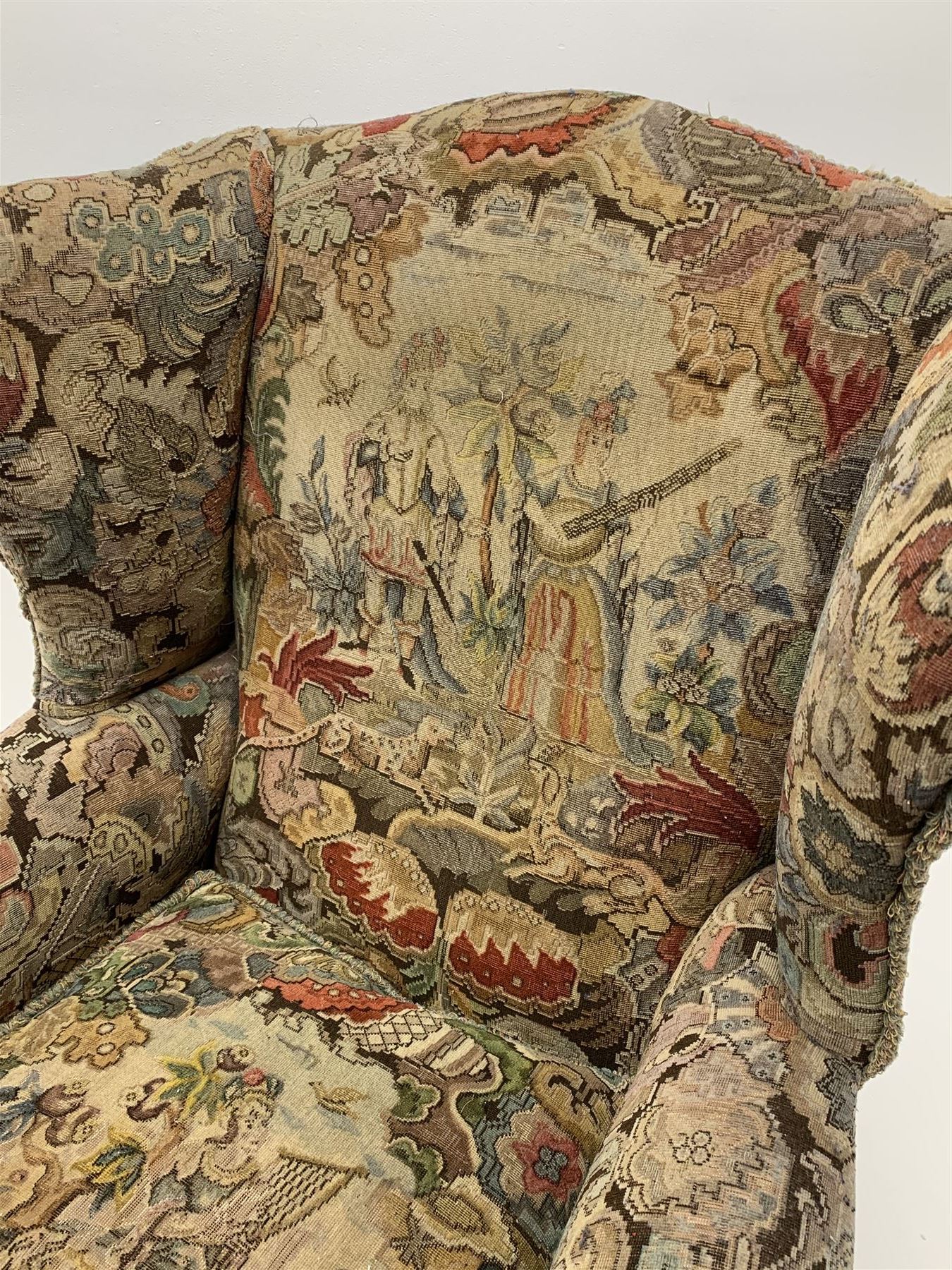 Matched pair early 20th century Queen Anne style wingback armchairs, walnut framed, sprung seats with seat cushions upholstered in needle work cover, shell carved cabriole front feet