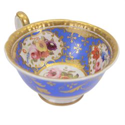 H&R Daniel trio, coffee cup, teacup and a saucer, circa 1825, Gadroon shape with D handle, painted with reserves of fine foliate sprays against a blue ground with gilt trellis detail, coffee cup including handle H8.5cm, saucer D14cm