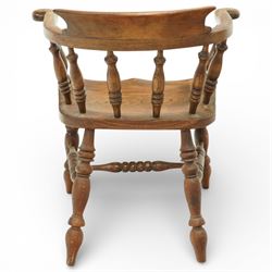 20th century captain’s oak smoker’s chair, with curved horseshoe back rail, turned spindle supports, shaped solid seat, turned legs united by stretchers