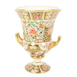 Royal Crown Derby campana vase, decorated in imari pattern, with gilt handled upon a circu...