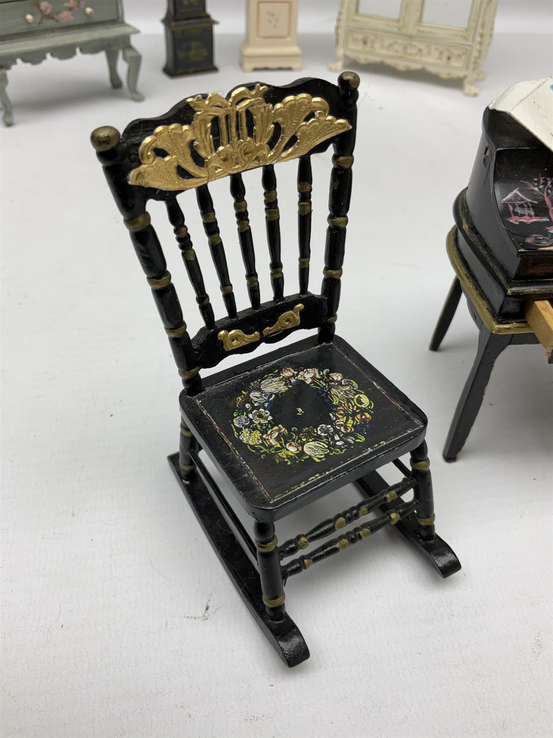 Collection of miniature dolls house furniture, to include five drawer chest painted with blossom, cream and gilt double door mirrored wardrobe, four piece lacquered style desk set, three piece suite, writing desk, wash stand, Knoll style sofa etc (14)