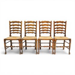 Set of eight country ladderback chairs (6+2), shaped ladderback over a rush seat, raised on turned supports, united by stretchers