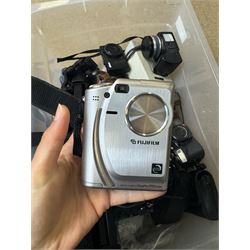 Collection of cameras and camera equipment, including Voigtlander Vitomatic I, Nikon Coolpix P340, Nikon Coolpix S9100, Olympus SP-510UZ, tripod, cases, etc