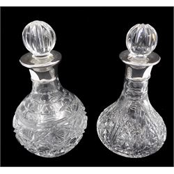 Two small modern silver mounted cut glass decanters, the first example of squat bulbous form, the body with navette, octagonal and hobnail cut decoration, with conforming stopper, the silver collar hallmarked Barker Ellis Silver Co, Sheffield 2005, H19cm, the second example, a ships decanter, with hobnail cut star decoration and conforming stopper, the silver collar hallmarked C J Vander Ltd, Sheffield 2005, H19cm, with boxes
