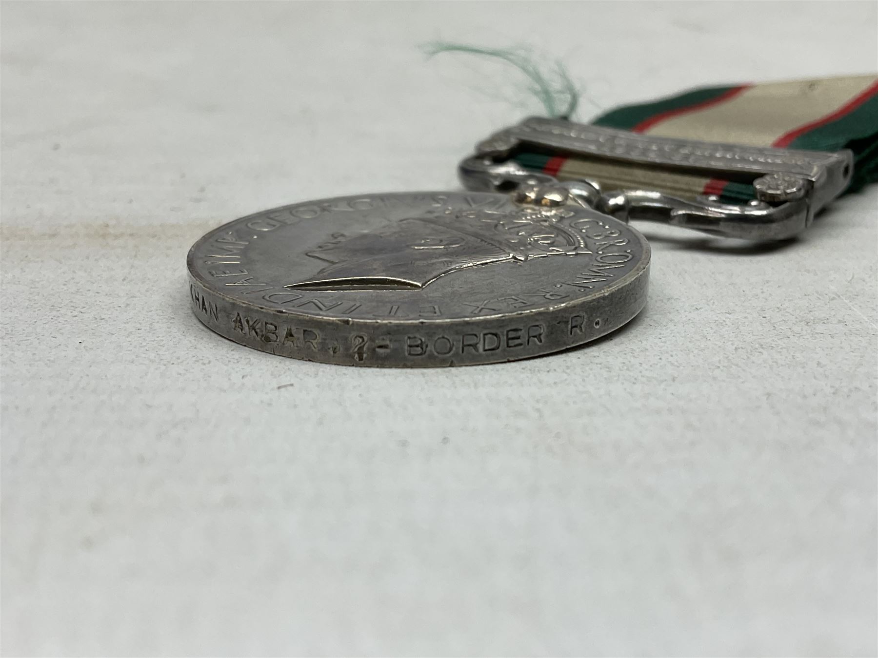George VI India General Service Medal with North West Frontier 1936-37 clasp awarded to Bearer Khan Akbar 2-Border R.; with ribbon
