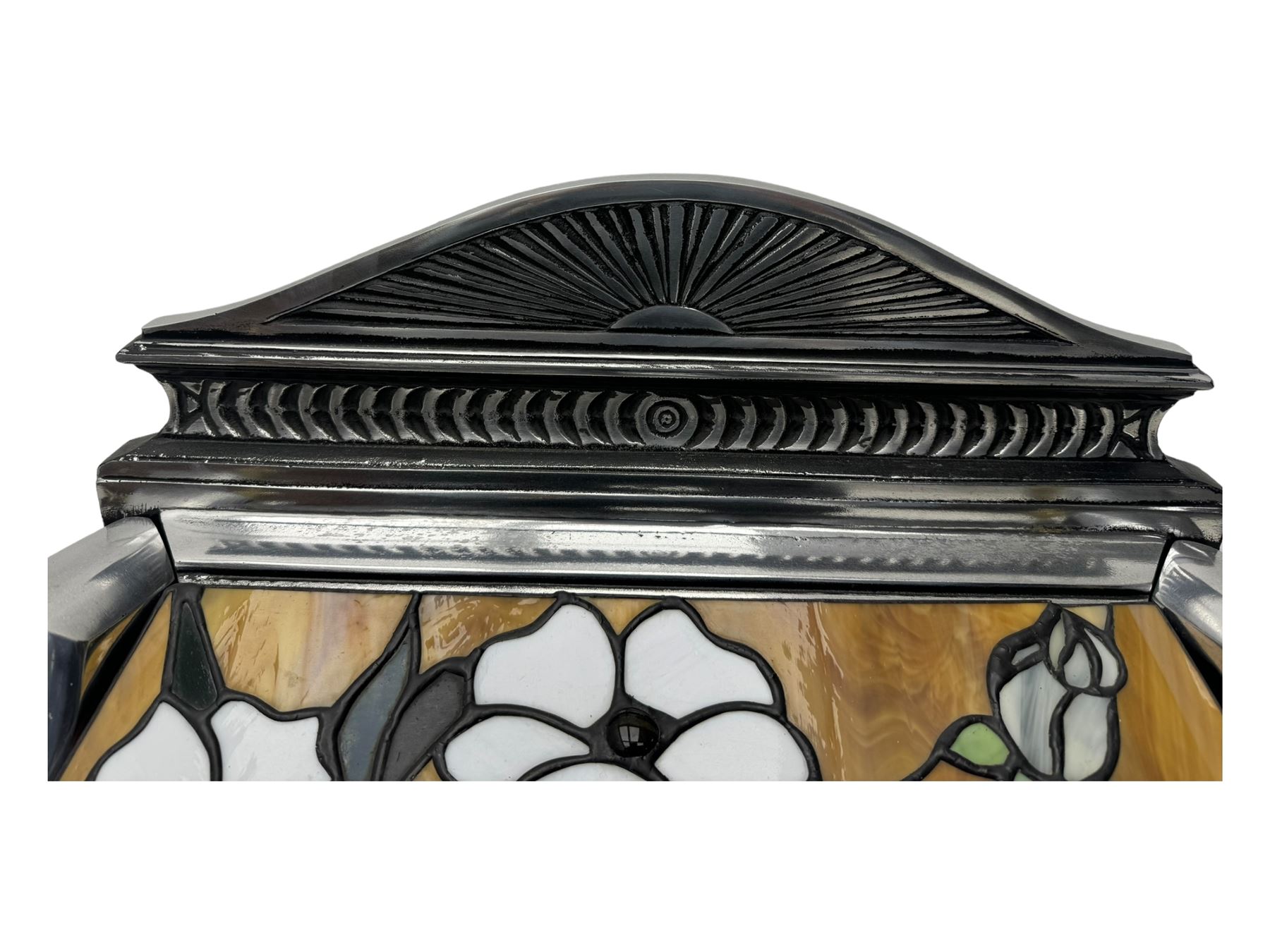 Stained glass and cast iron electric fireplace, arched top with decorative finials, stained glass front panel with floral motifs, flanked by cast iron scrolls, raised on scroll supports