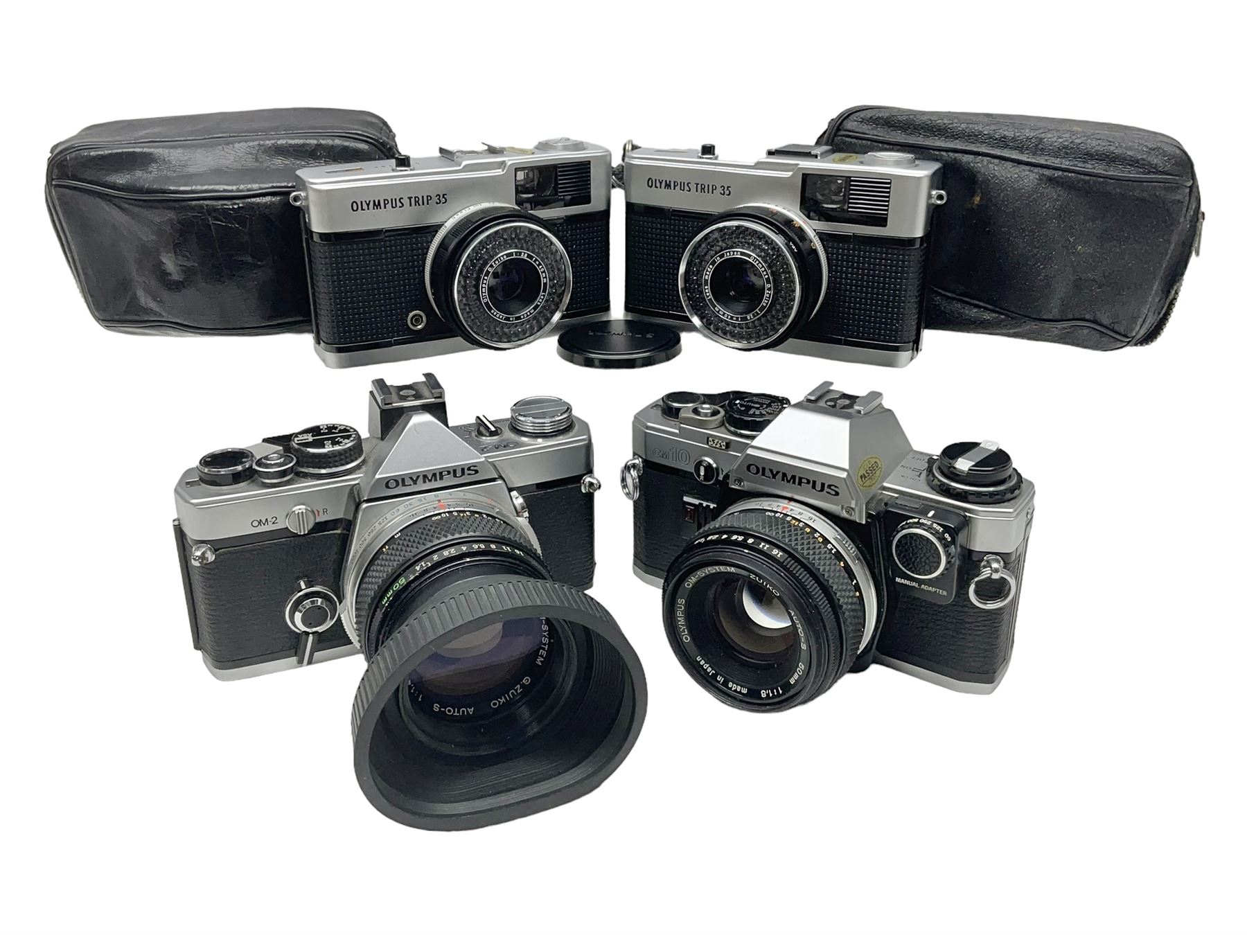 Four Olympus camera bodies, including Olympus OM10, serial no 20744269, with 'Olympus OM-System Zuiko Auto-S 50mm 1:1.8' lens serial no 3633644, Olympus OM-2 camera body serial no 460280 with 'Olympus OM-System G.Zuiko Auto-s 1:1.4 f=50mm' lens, serial no 729750, etc 