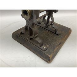 Victorian cuff and collar tabletop mangle, the ribbed brass rollers in a cast iron frame mounted on a wooden base