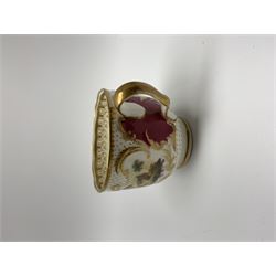Early 19th century Minton coffee cup and saucer, decorated in pattern no 792, painted with landscape panels interspersed with claret panels and heightened throughout with gilt, cup H6cm, saucer D14.5cm

