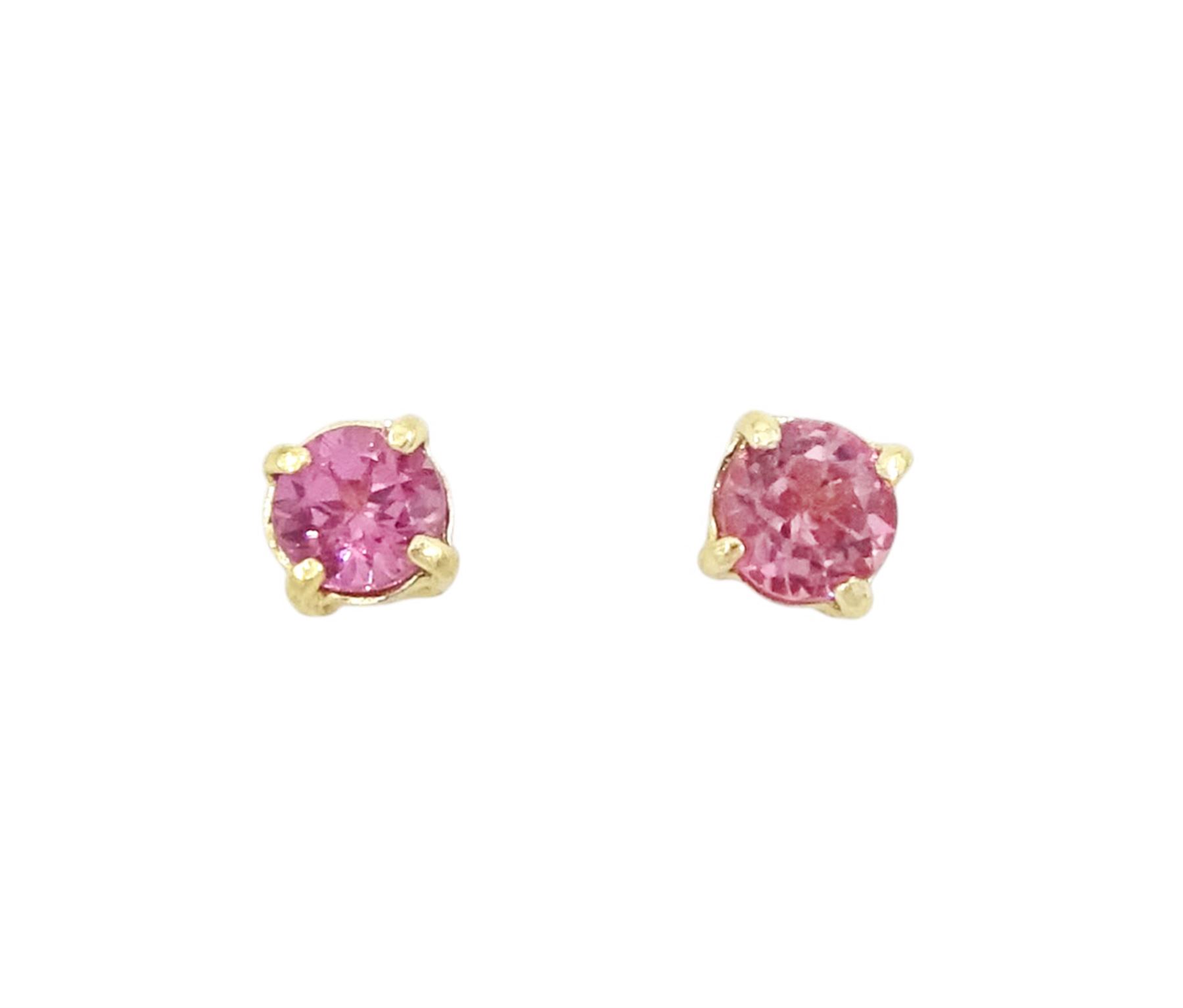 Pair of 9ct gold round cut garnet stud earrings, stamped
