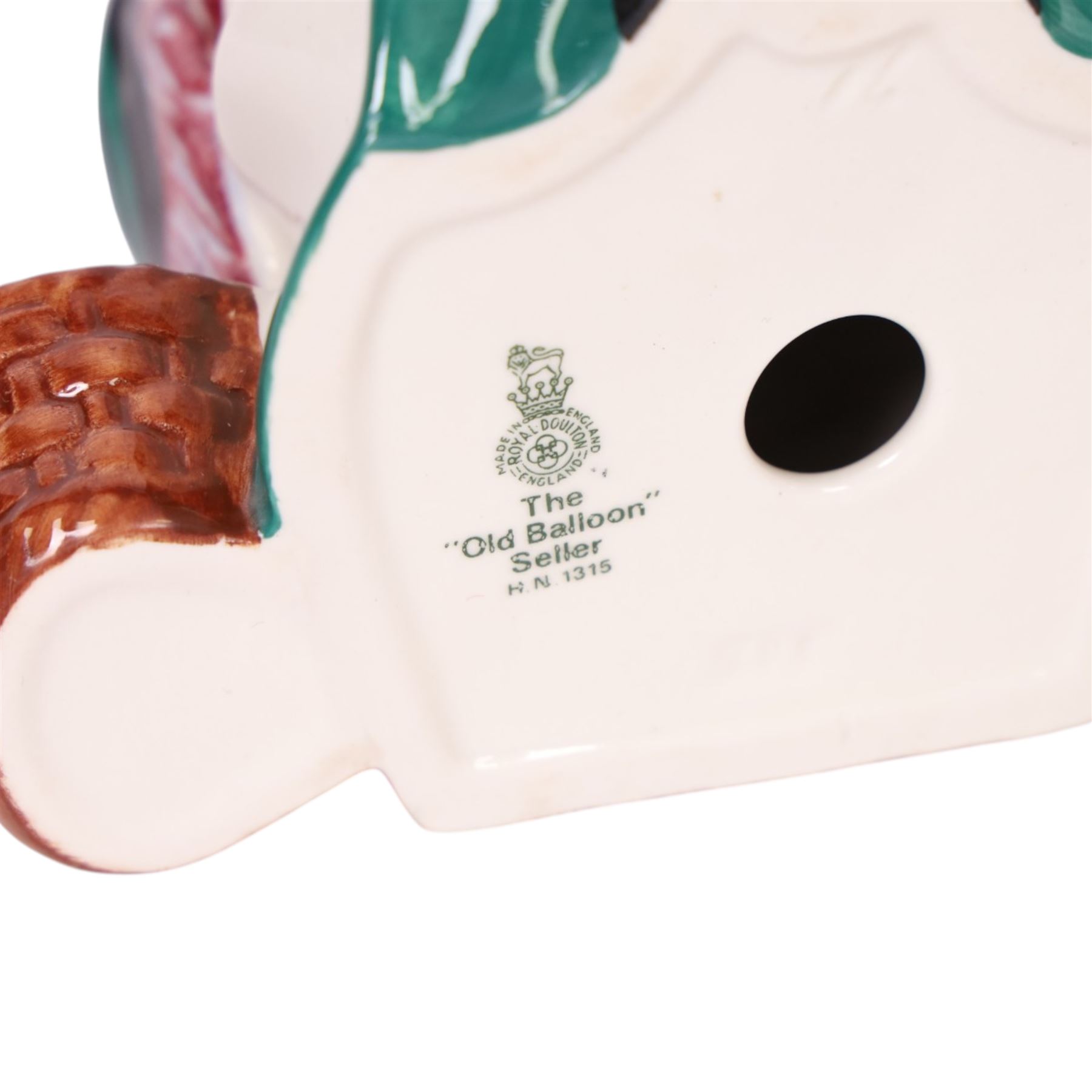 Three Royal Doulton figures, comprising  Churchill HN3057, The Old Balloon Seller HN1315 and The Balloon Man HN 1954