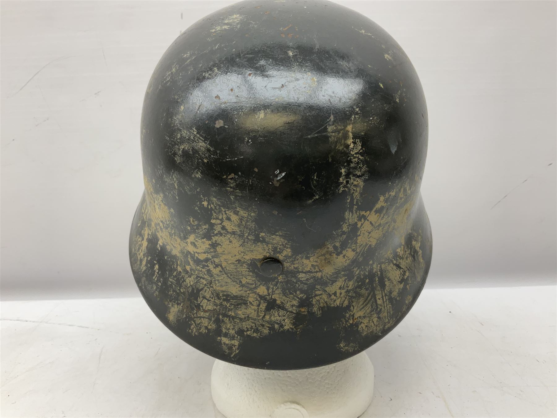 WW2 German steel helmet painted in undecaled Luftwaffe bluey grey with leather liner and chin strap stamped '58', the skirt impressed '1250'