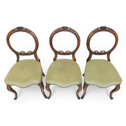 Victorian mahogany dining suite, oval tilt top dining table raised on a quatriform base with paw feet, together with a set of six balloon back dining chairs with green upholstery with cabriole legs 