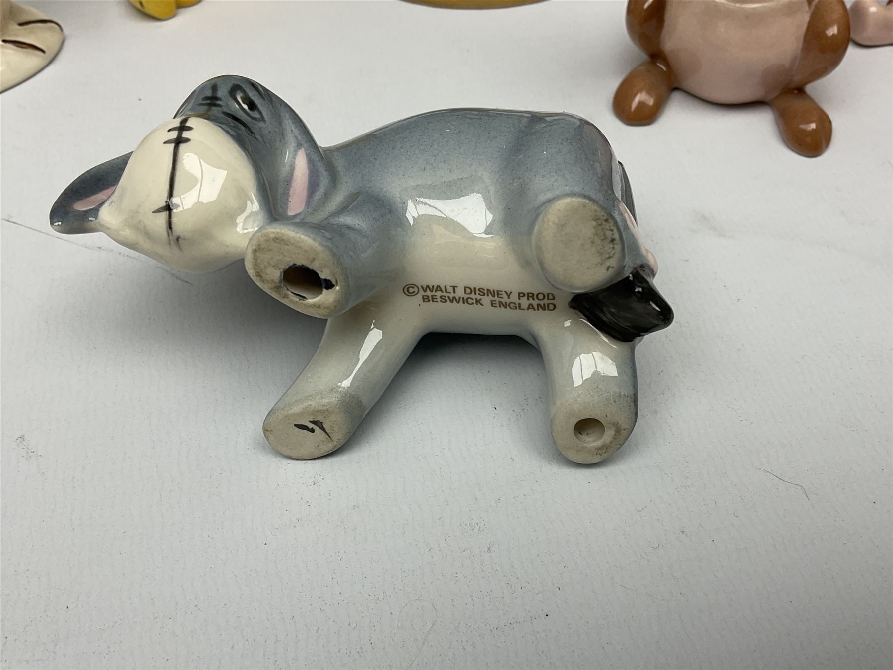 Seven Beswick Winnie the Pooh figures, comprising Pooh Bear, Tigger, Piglet, Kanga, Mr Rabbit, Owl, and Eeyore, together with two Royal Doulton Winnie the pooh Christmas Collection figures, 'The Most Perfect Tree in all the Wood', and 'Christopher Robin Dresses the Tree', (9)  