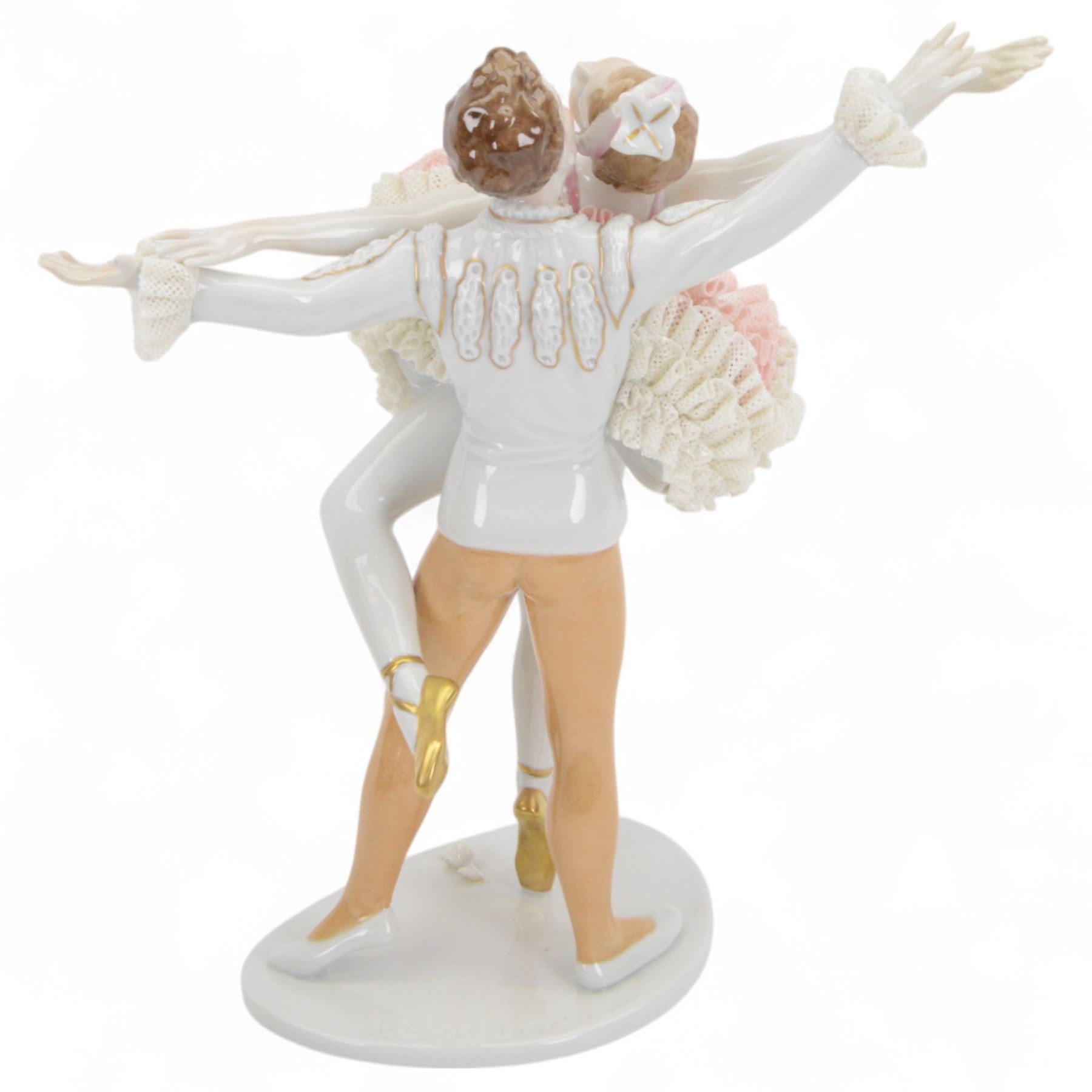 Unterweissbach lace figure, designed by K. Steiner, modelled as two ballerinas, the female figure with lace tutu, the male figure with lace cuffs, upon a shaped base with incised signature, with printed mark beneath, H26cm