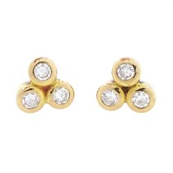 Pair of 9ct gold trefoil diamond stud earrings, each bezel set with three round brilliant cut diamonds