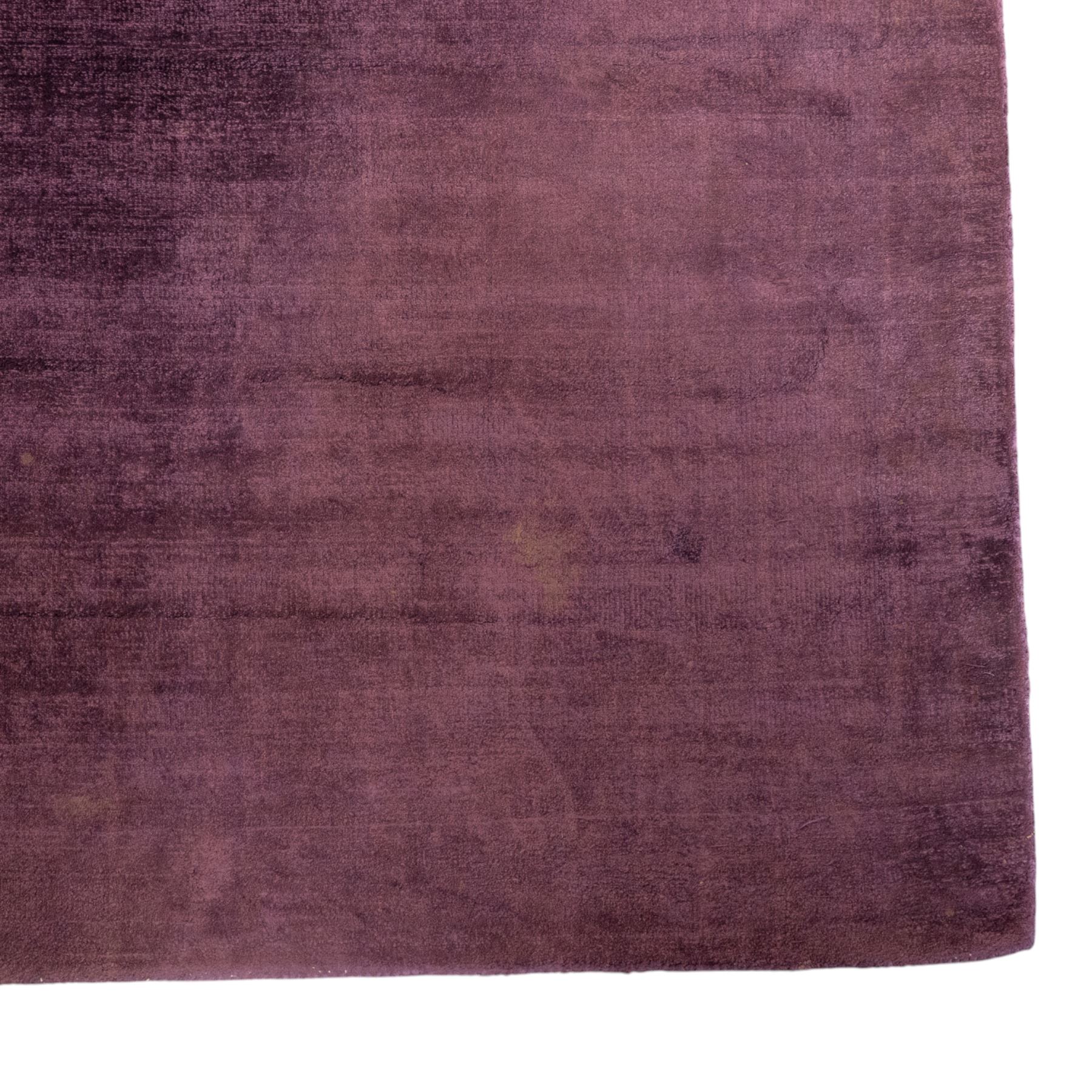 Jacaranda - 'Satara' damson coloured low pile hand woven rug, tencel yarn with cotton backing 