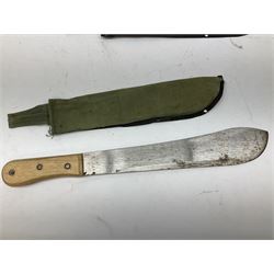 Two unmarked late 20th century machete knives with 37cm blades and fabric sheaths; pair of British Army canvas leggings/spats; and a 50-round clip containing forty-nine inert rounds