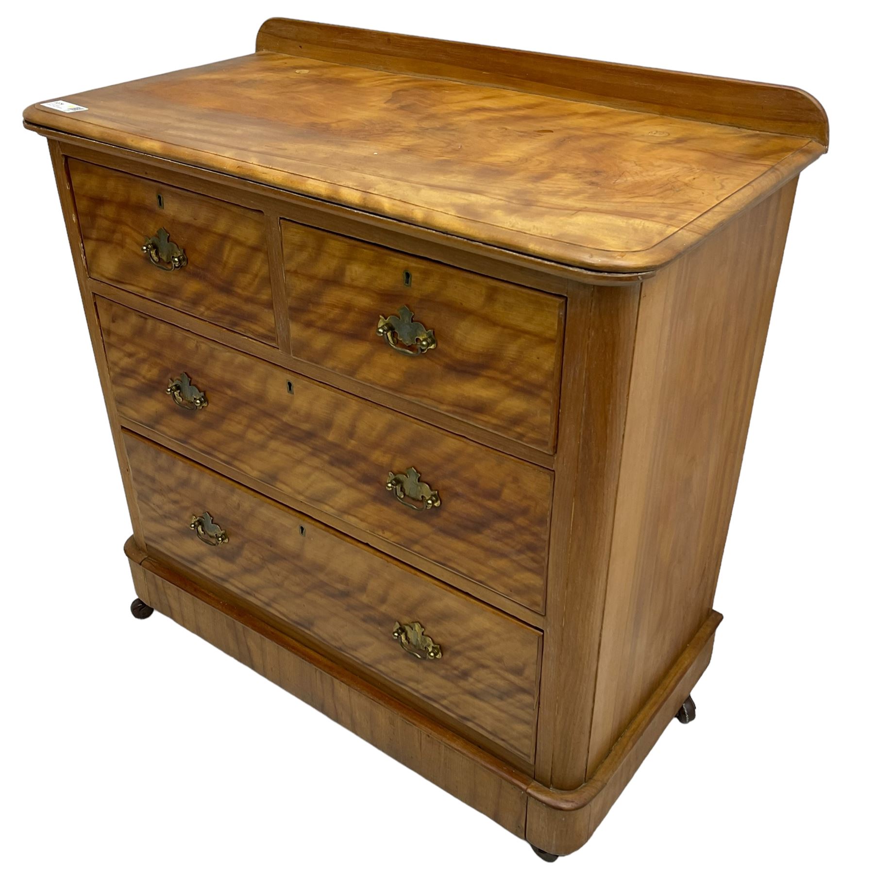 Victorian satin walnut chest, raised back over two short and two long drawers, skirted base with castors