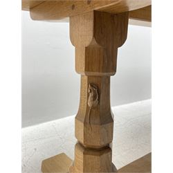 'Mouseman' oak dining table, rectangular adzed top on twin octagonal pillar base, sledge feet joined by floor stretcher, by Robert Thompson of Kilburn