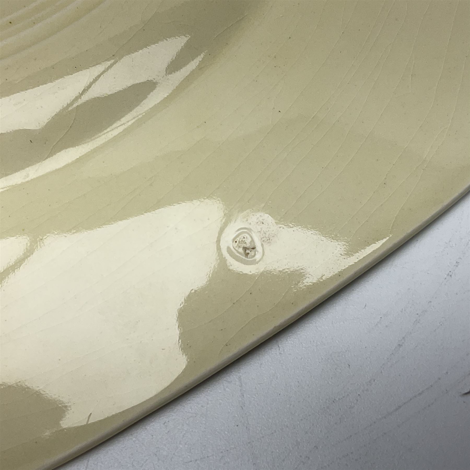 Clarice Cliff Bizarre for Newport Pottery Orange Roof Cottage pattern plate, circa 1932, hand painted with a stylised cottage and bridge landscape with yellow, orange and black banding, black printed mark beneath, D22cm 