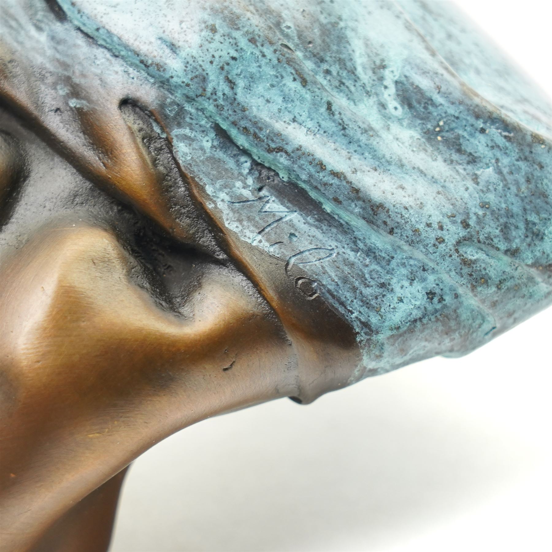 Bronze figure, modelled as a nude woman removing her shirt, signed Milo, H17cm