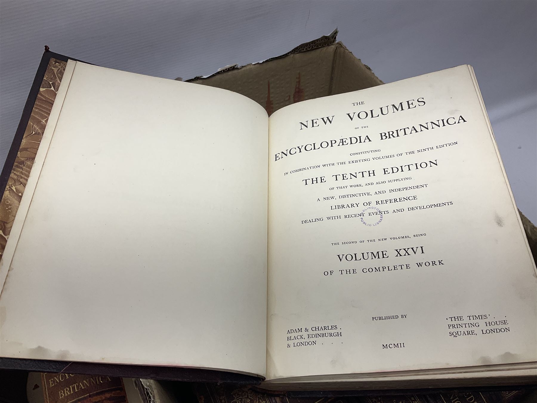 Thirty six volumes of Encyclopaedia Britannica with gold tooled red leather spines in various editions 