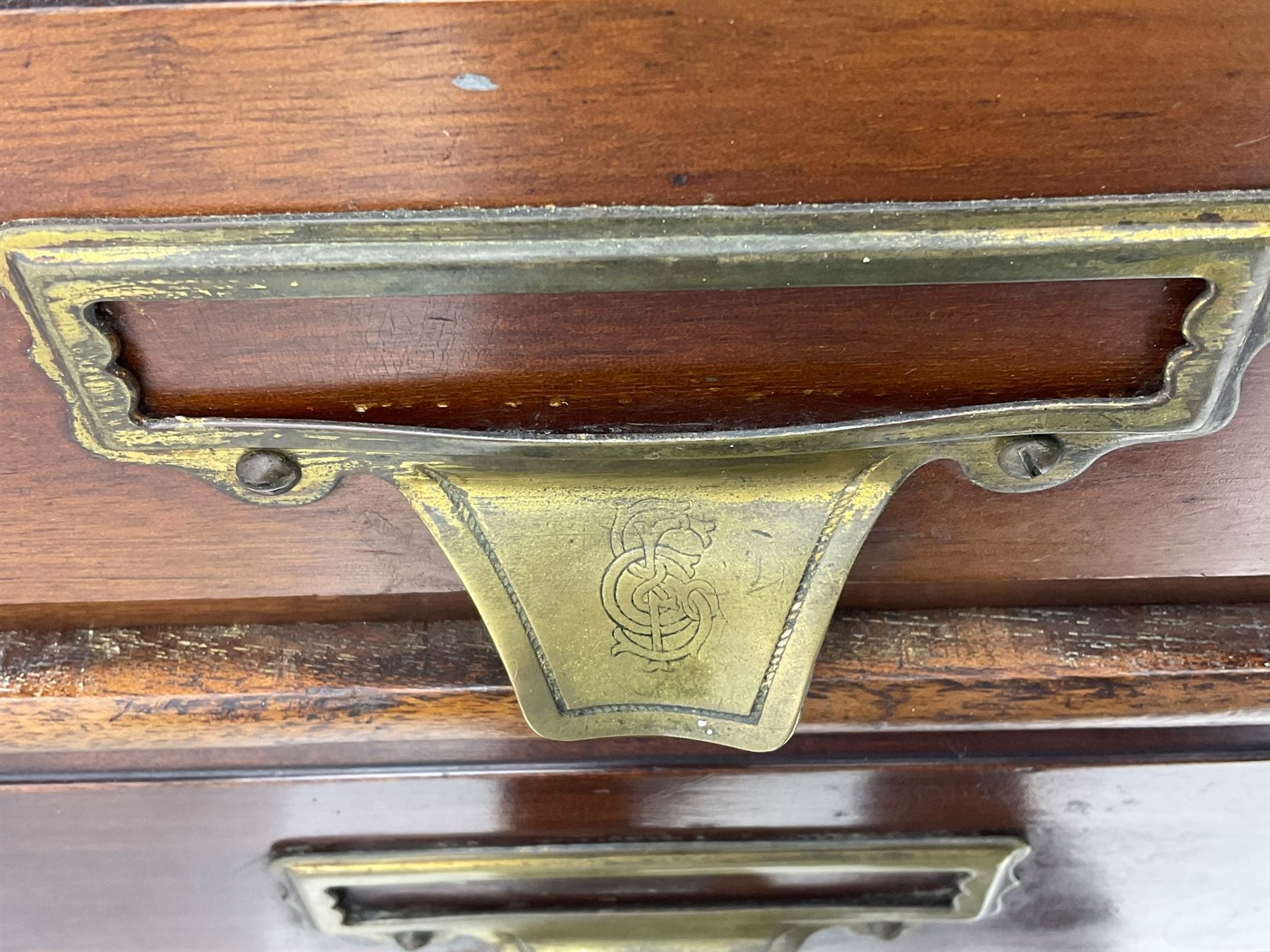 The Shannon Limited - late Victorian walnut filing cabinet, fitted with twenty-four small filing drawers, each with brass handle with label holder, fluted uprights, double cupboard below enclosed by two panelled doors, on turned feet, with brass plaque inscribed 'The Shannon, Limited, Ropemaker St. London, E.C.'
