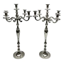 Pair of four branch candelabras, urn-shaped nozzles raised upon scroll branches supported from tapering central stem, with circular base, H70cm