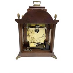 Hermle - 20th century 8-day chiming bracket clock, in a break arch mahogany case with carrying handle, brass dial with silvered chapter ring, chiming the hours and quarters on five gong rods, spring driven three train movement with a floating balance escapement. 