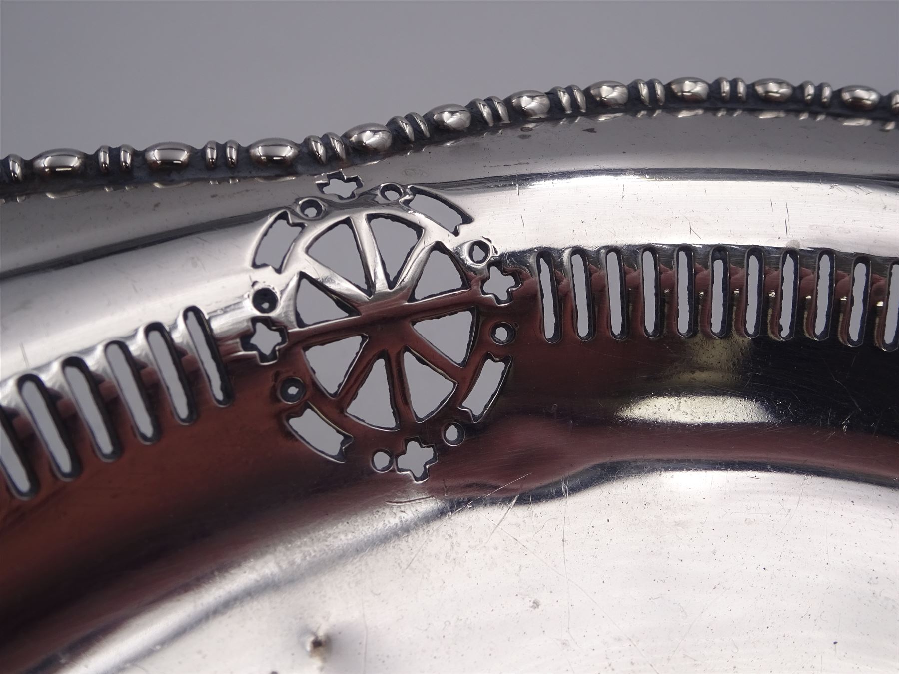Early 20th century pedestal bowl, of circular form, with lobed bead and dart rim, the sides with pierced wheel, cross and dart decoration, upon spreading circular foot, hallmarked Barker Brothers, Chester 1917