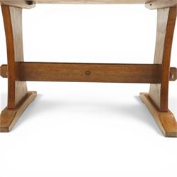 Acornman - 5' adzed oak dining table, rectangular top above a trestle base united by a stretcher with carved acorn signature, by the workshop of Alan Grainger of Brandsby