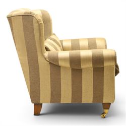 Alstons - 'Ixworth' armchair, upholstered in striped fabric, with loose seat cushions and scrolled arms, brass front castors
