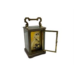 A late 19th century French timepiece carriage clock in a corniche case with a white enamel dial, Roman numerals and minute markers, lever platform escapement with timing screws, with four bevelled glazed panels to the sides and a rectangular panel to the top of the case. 