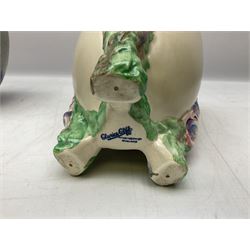 1930s Carlton Ware Art Deco Garden pattern vase of shouldered ovoid form, decorated with blue, pink and yellow flower heads on a mottled blue and white ground, pattern no. 3413, with printed and painted marks beneath, H19cm, together with a Clarice Cliff My Garden pattern vase, raised upon three feet with blue, pink and purple moulded Hollyhock design, H20cm, with Clarice Cliff Wilkinson Ltd England marks beneath