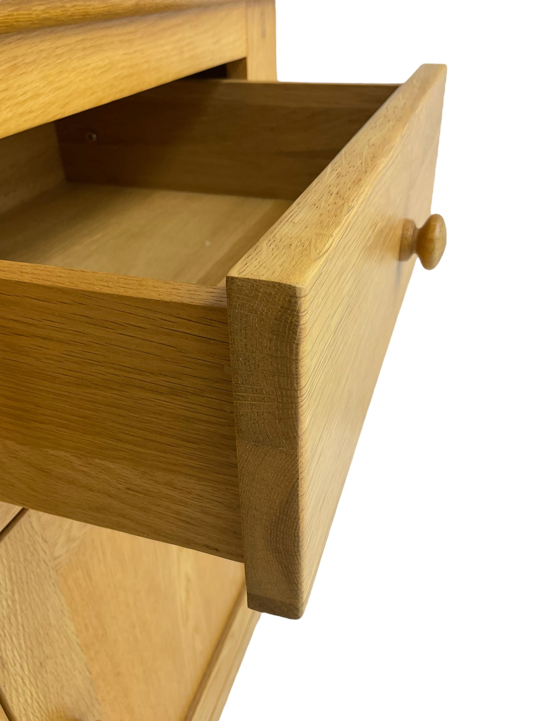 Contemporary light oak bookcase display cabinet, fitted with  two glazed doors enclosing two shelves, above two drawers and cupboards
