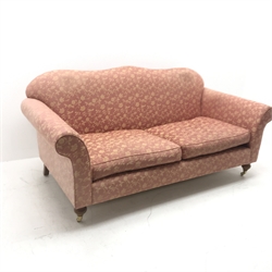 Wesley Barrell Hinton two seat sofa, shaped cresting rail, scrolling arms, turned supports on castors, W200cm
