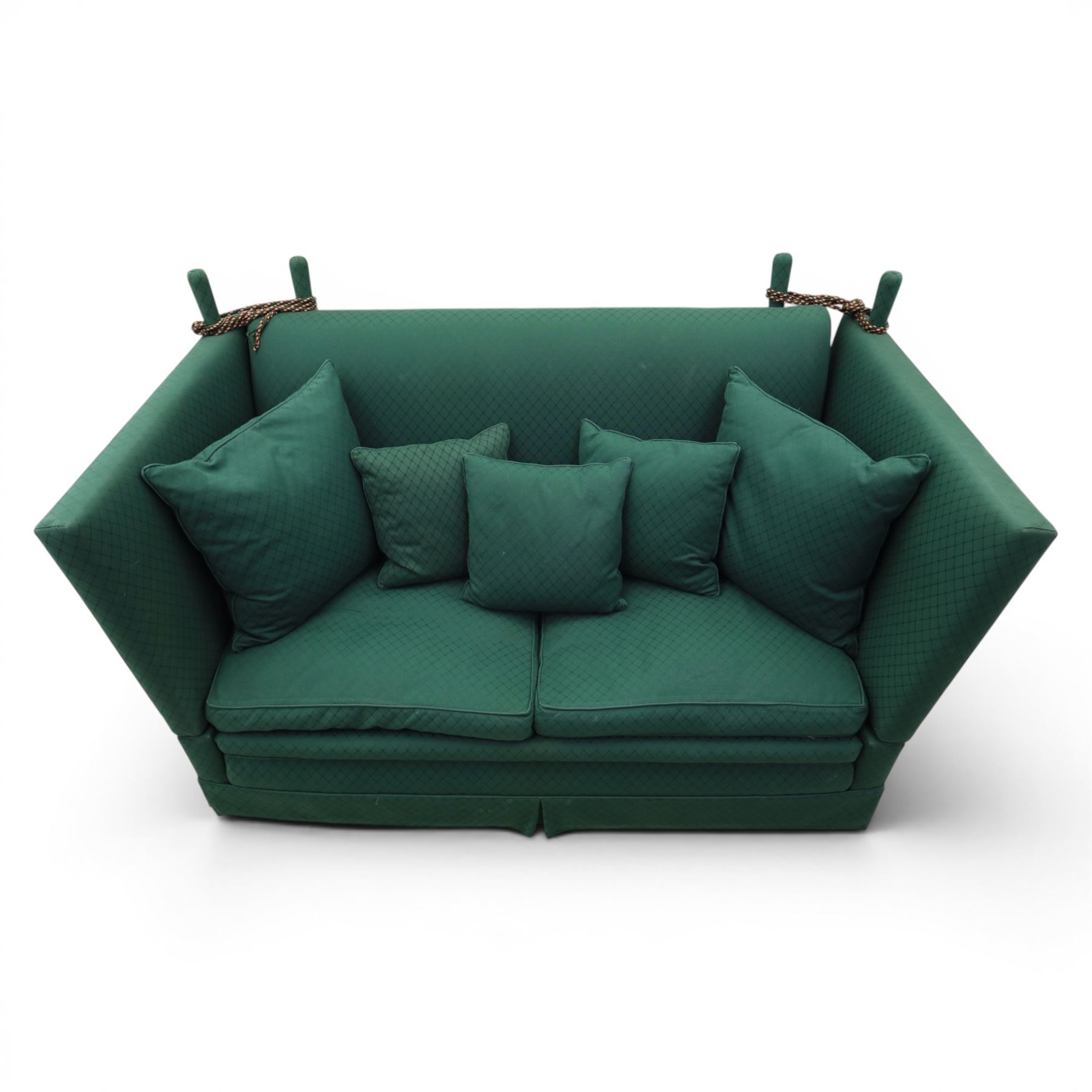 Late 20th century two-seat Knole sofa, covered in green woven fabric with lattice pattern, high panelled back and hinged drop arms secured by braided cords, loose cushioned seat and back with additional scatter cushions, on plinth base