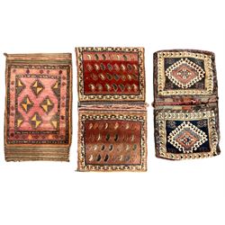 Antique Persian red ground saddle bag, decorated with all-over Boteh motifs, geometric patterned border (127cm x 68cm); Persian indigo ground saddle bag, decorated with two geometric ivory lozenges (113cm x 62cm); Persian red ground saddle bag decorated with lozenges and multi-band border (110cm x 65cm) 