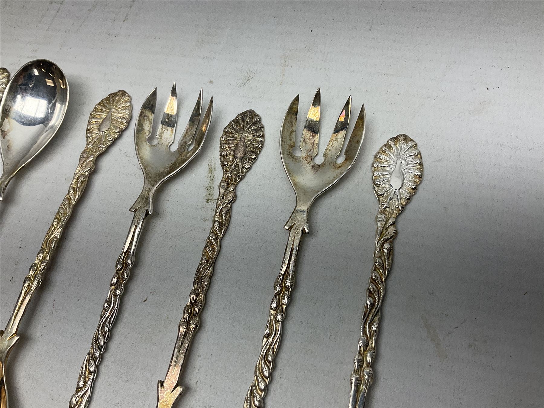 Set of four Continental silver spoons and forks, with stylised terminals, a number stamped S800, approximate weight 88.4 grams