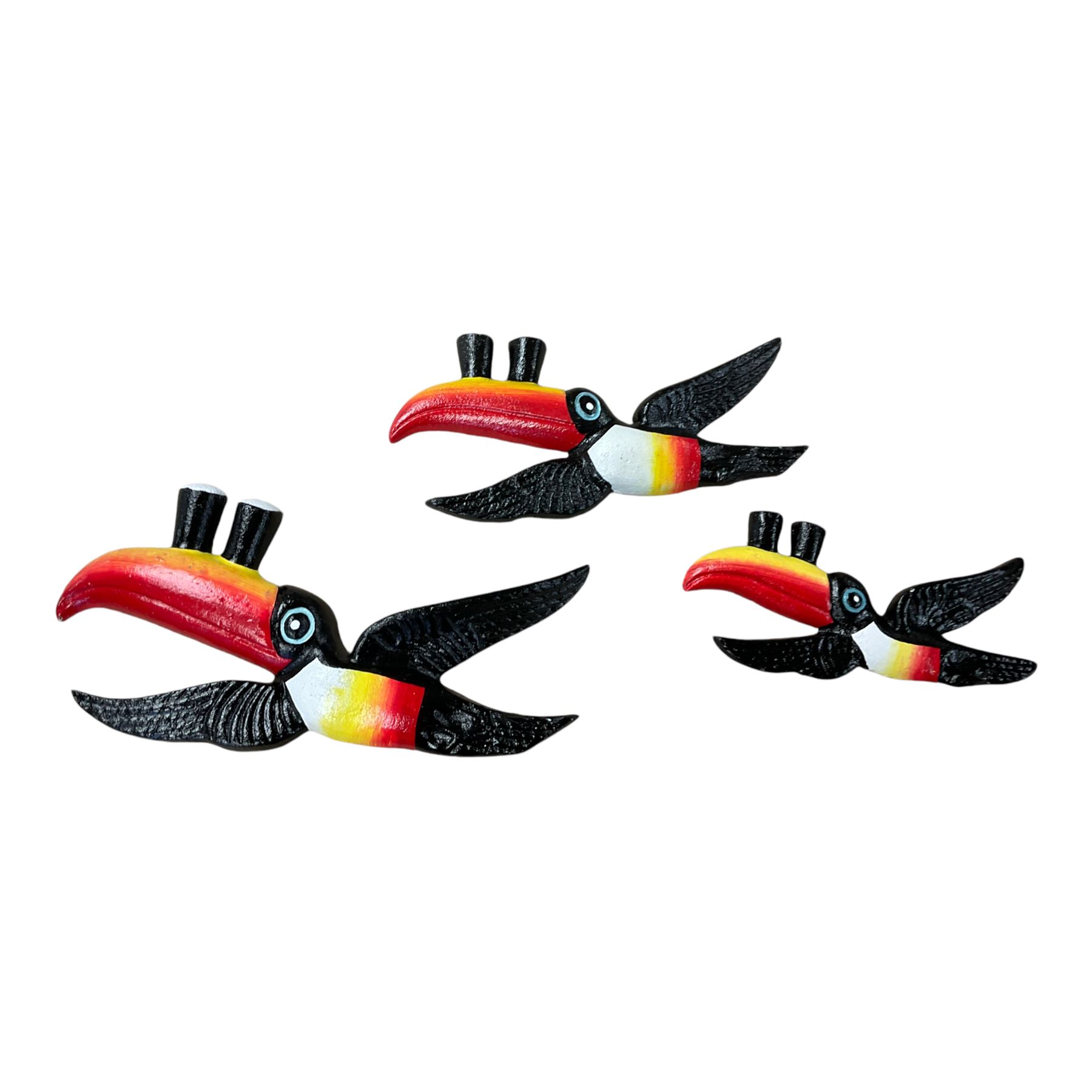 Three cast iron Guinness toucans in flight, together with two cast iron hooks