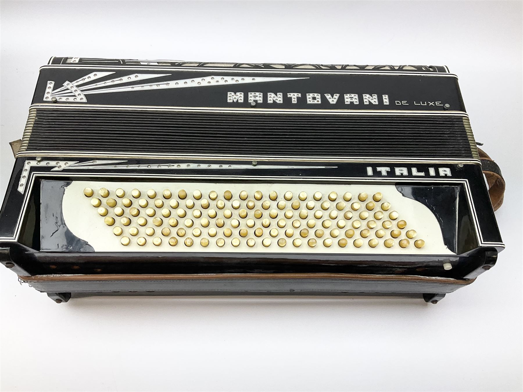 Italian Mantovani piano accordion with Art Deco style black and white case, twenty-four keys and one-hundred and twenty buttons L52cm in carrying case