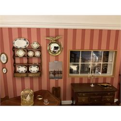 Good quality late 20th century dolls house by M. James dated 1995 in the form of a Beverley East Yorkshire Antique Shop called 'North Bar Antiques'; single-storey single-roomed shop with textured brick walls and flat roof, fully glazed hinged front with recessed hinged customer door and central window to the rear; comprehensively furnished with chests of drawers, pedestal desk, breakfast table, lowboy, two longcase clocks, delft rack with ceramics, occasional tables, pictures, Regency style mirror and collectibles; decorated walls with coving and picture rail and simulated floorboarding; wired for electric lighting; maker's plaque W61cm H42.5cm D41.5cm