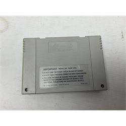 Two Super Nintendo Entertainment System (PAL) controllers, accessories and games. Super NES Game Commander with original box and instruction booklet, Super NES Nintendo Scope (1992) transmitter gun, receiver, Super NES Nintendo Scope 6 game with original instruction booklets. Further games to include ‘The Legend of Zelda a Link to the Past’, ‘Super Mario World’, ‘Super Mario Kart’, ‘The Lawnmower Man’, and ‘Exhaust Heat’, all with original instruction booklets. ‘PowerMonger’ and Disney’s ‘Aladdin’ game cartridges only 