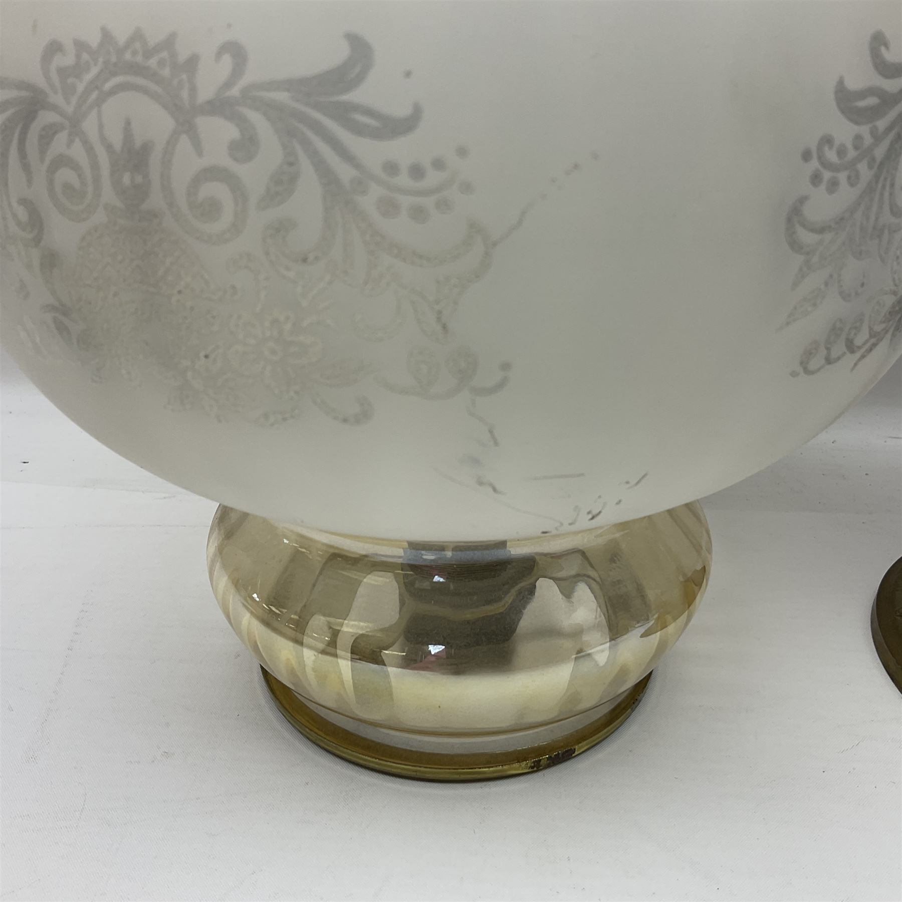 Gilt metal table lamp, heavily embossed with flowers and butterflies, with fluted frosted glass shade, H56cm