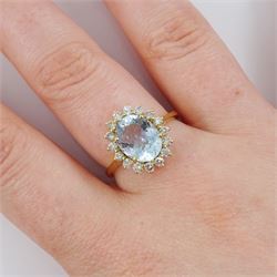 18ct gold aquamarine and diamond cluster ring, single oval cut aquamarine of approx 2.05 carat, with sixteen round brilliant cut diamond surround, stamped, total diamond weight approx 0.40 carat