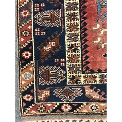 Turkish red and blue ground rug, geometric patterned field, repeating border, 272cm x 202cm